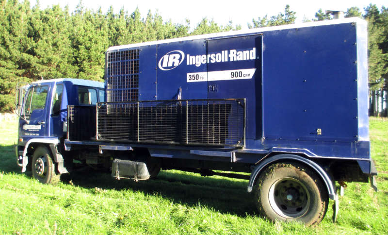 Well drilling 3 Ingersoll Rand 350psi 900cfm compressor truck in WellDrillers blue livery