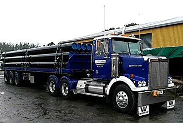 Blue Western Star truck loaded with drill casing on a 12 metre semi-trailer