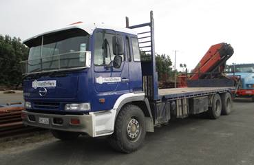 WellDrillers Hino flat-deck crane truck fitted with a Palfinger 17500 crane